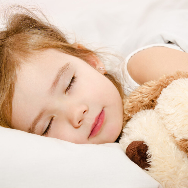 Little girl sleeping with her teddy bear